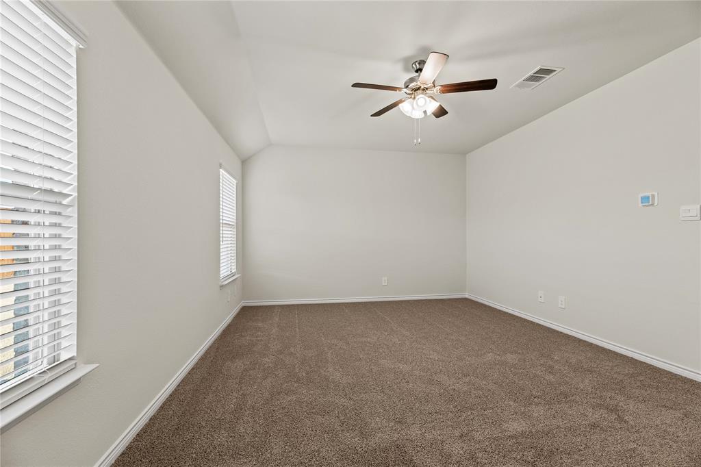 411 Revolution Road Fate, TX 75087 - Photo 24 of 34 a view of a big room with windows and chandelier fan