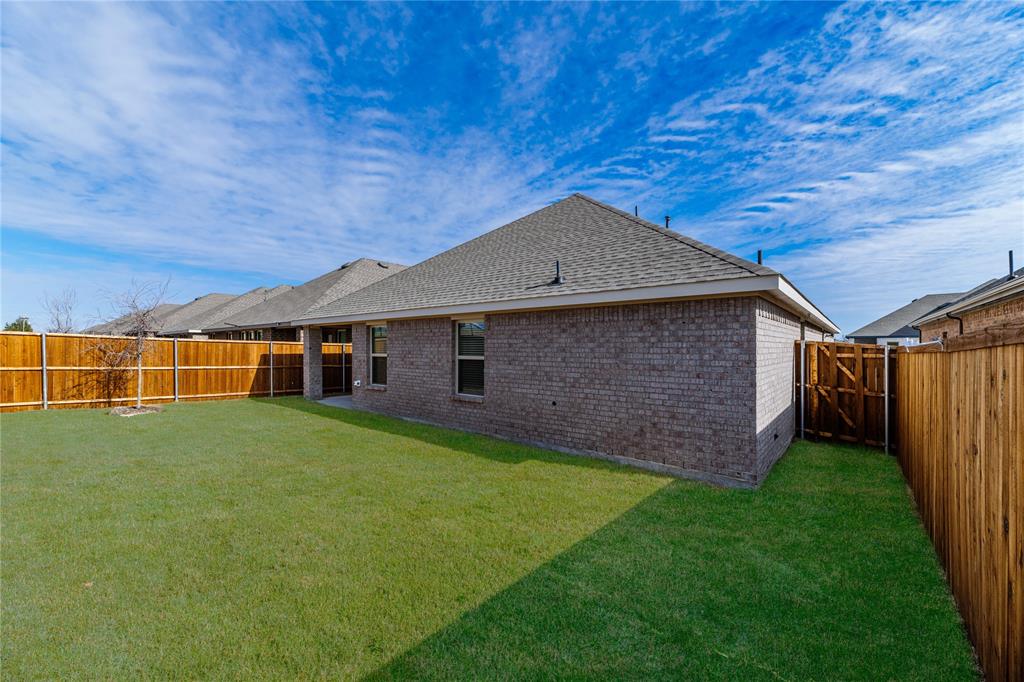 411 Revolution Road Fate, TX 75087 - Photo 29 of 34 a backyard of a house with lots of green space