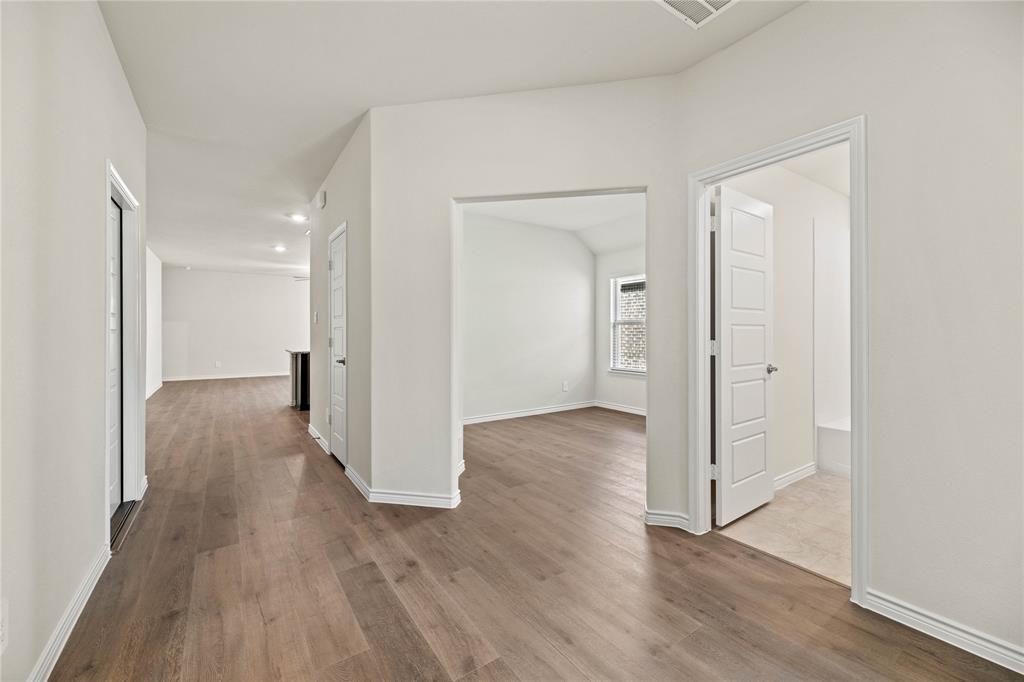 411 Revolution Road Fate, TX 75087 - Photo 5 of 34 a view of a hallway with wooden floor