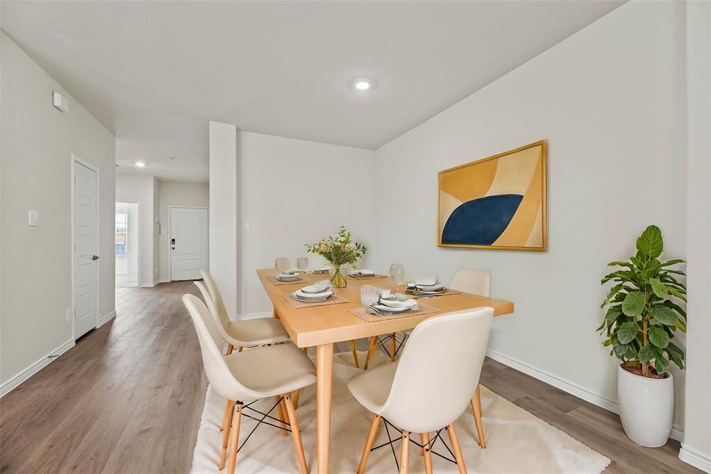 411 Revolution Road Fate, TX 75087 - Photo 9 of 34 a dining room with furniture and a potted plant