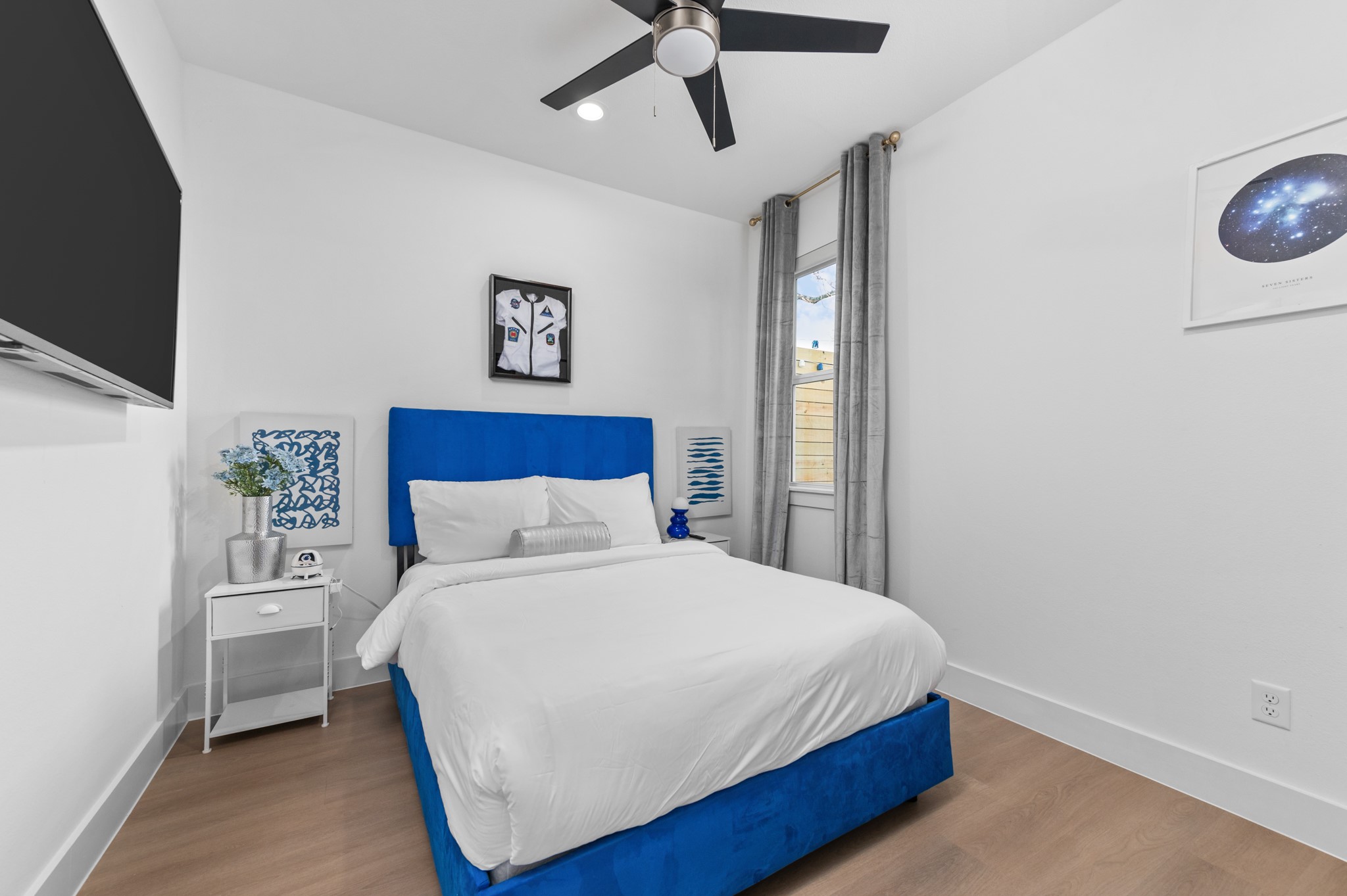 3313 Hadley Street, Unit B Houston, TX 77004 - Photo 6 of 26 a bedroom with a bed and a flat screen tv
