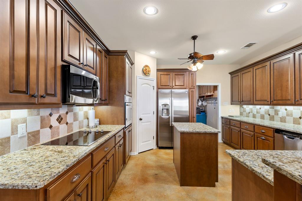 3794 County Road 1089 Celeste, TX 75423 - Photo 10 of 40 a kitchen with granite countertop a sink stove and refrigerator