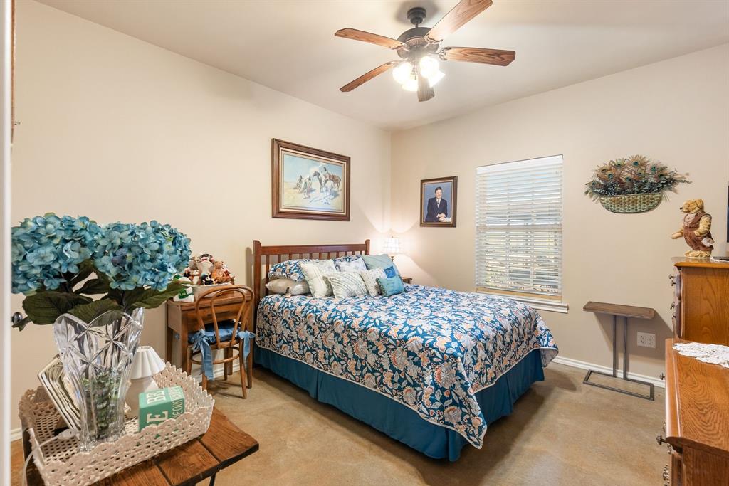 3794 County Road 1089 Celeste, TX 75423 - Photo 23 of 40 a bedroom with a bed and a chandelier
