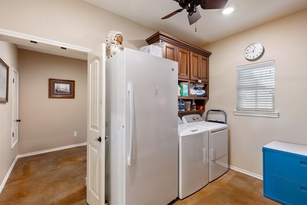3794 County Road 1089 Celeste, TX 75423 - Photo 25 of 40 Laundry room featuring a ceiling fan, separate washer and dryer, and cabinet space