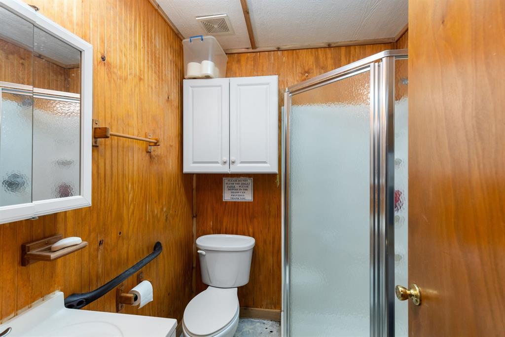 3794 County Road 1089 Celeste, TX 75423 - Photo 33 of 40 a white toilet sitting next to a bathroom sink