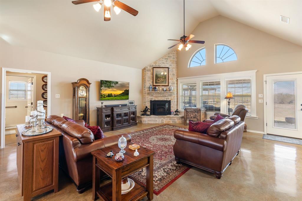 3794 County Road 1089 Celeste, TX 75423 - Photo 7 of 40 a living room with furniture a fireplace and a chandelier