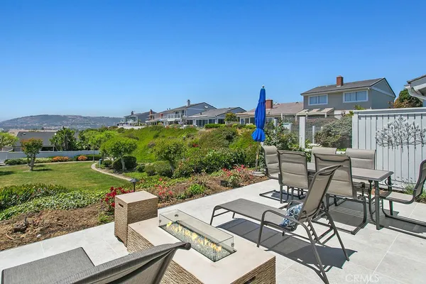 a view of a patio with table and chairs and potted plants