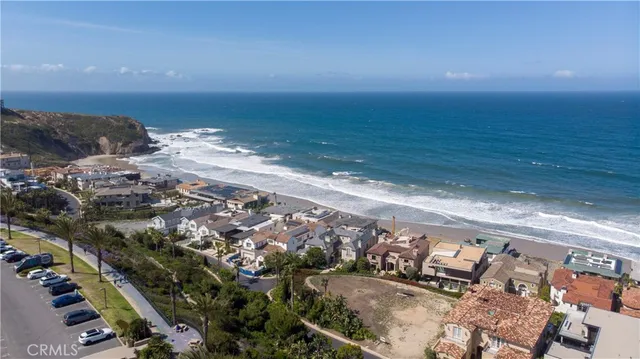 a view of a street with cars parked