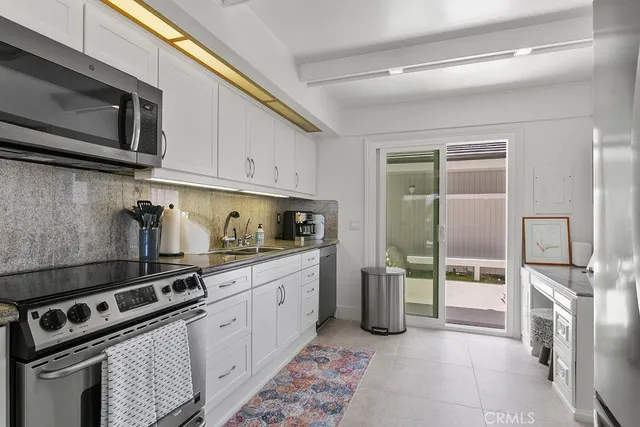 a kitchen with stainless steel appliances granite countertop a stove and a refrigerator