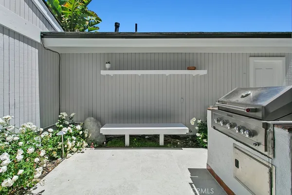 a bathroom with a granite countertop sink and a shower