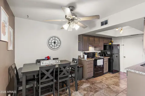 a view of a dining room with furniture and a kitchen