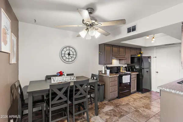 a view of a dining room with furniture and a kitchen