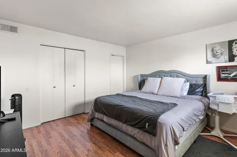 a bedroom with a bed and wooden floor