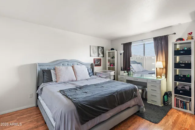 a bedroom with a large bed and a chandelier