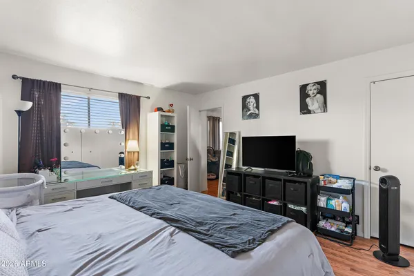 a bedroom with a bed and a flat screen tv