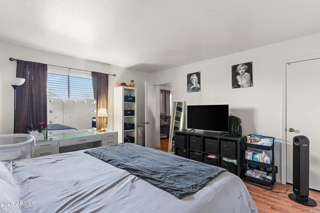a bedroom with a bed and a flat screen tv