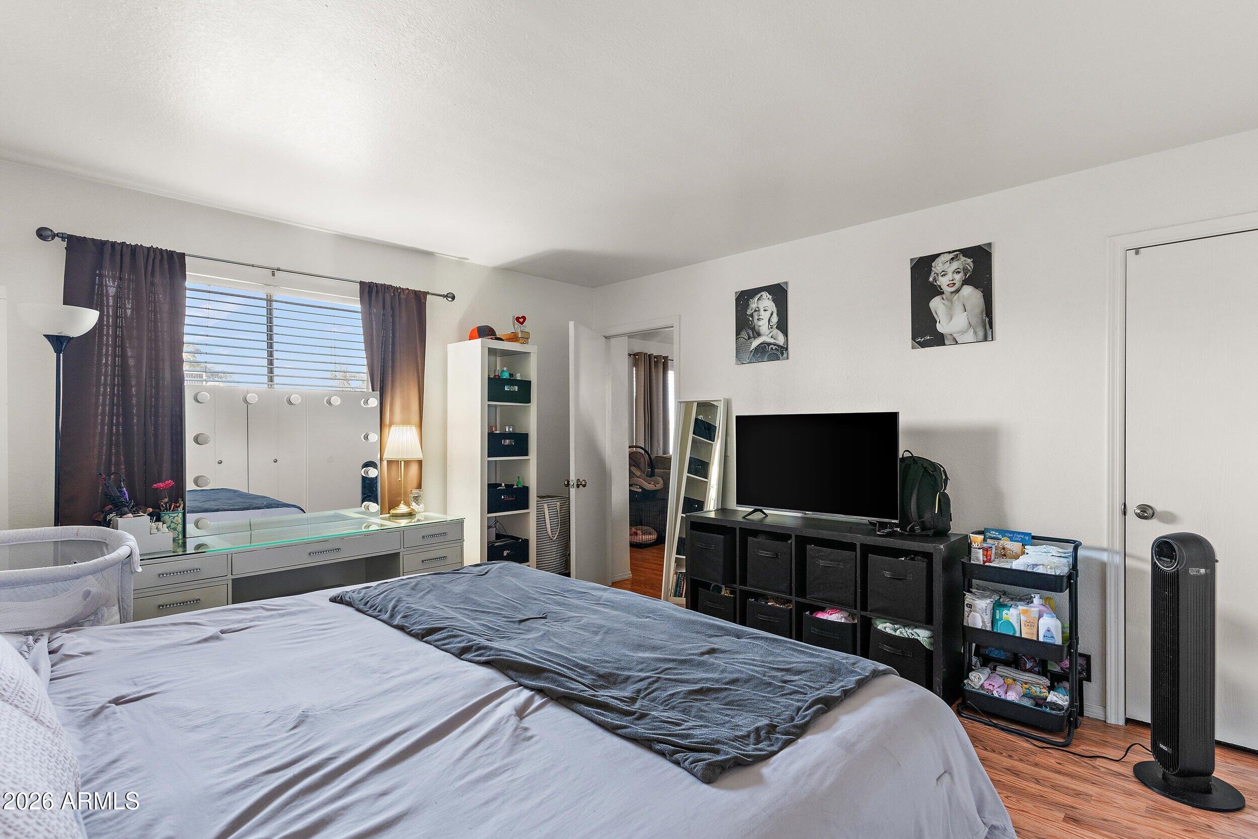 222 West Brown Road, Unit 57 Mesa, AZ 85201 - Photo 17 of 21 a bedroom with a bed and a flat screen tv