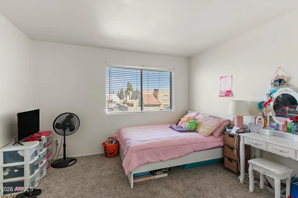 a bedroom with a bed and a window