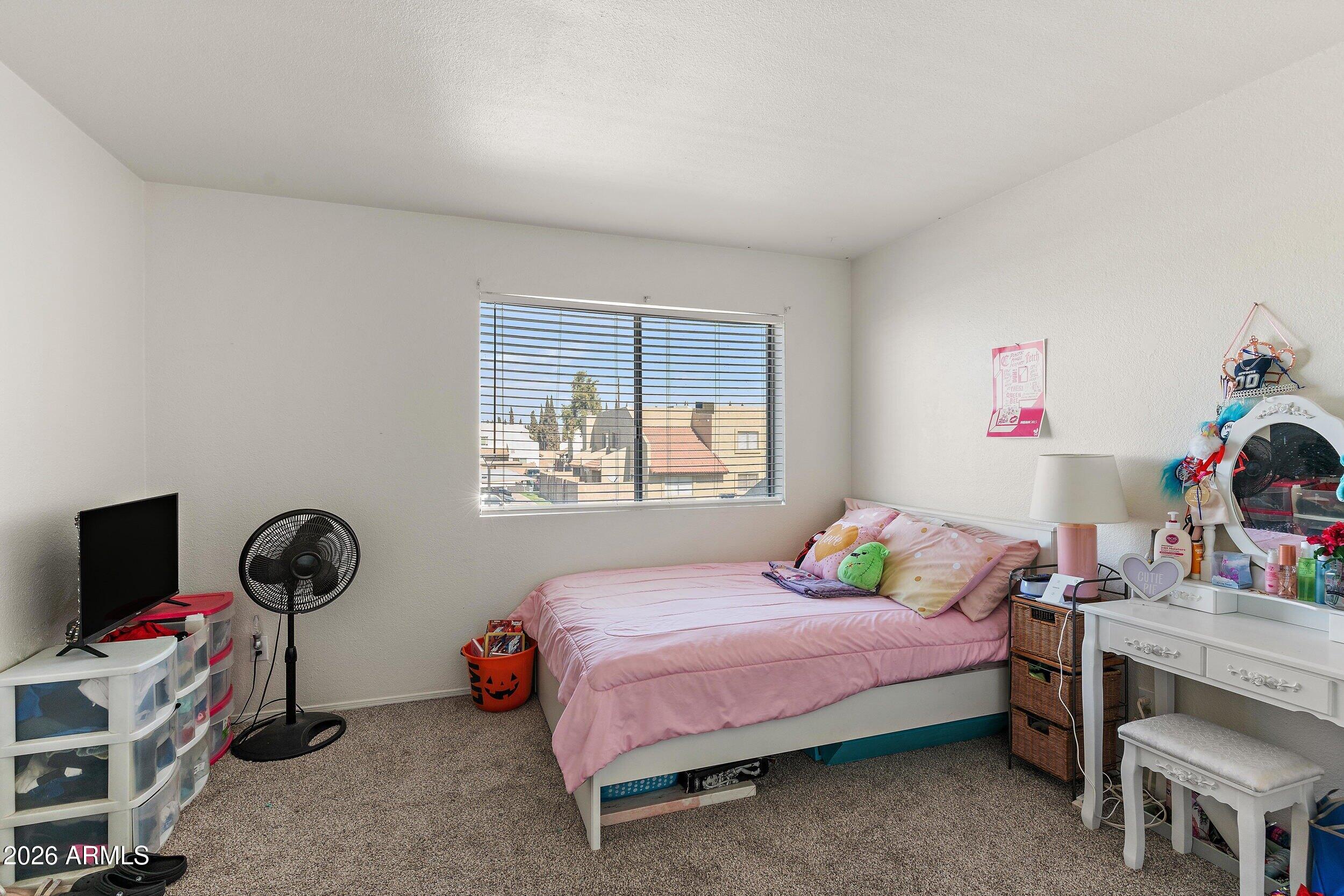 222 West Brown Road, Unit 57 Mesa, AZ 85201 - Photo 19 of 21 a bedroom with a bed and a window
