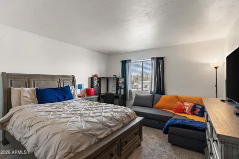 a bedroom with a bed and dresser