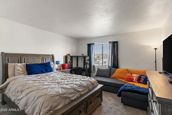 a bedroom with a bed and dresser