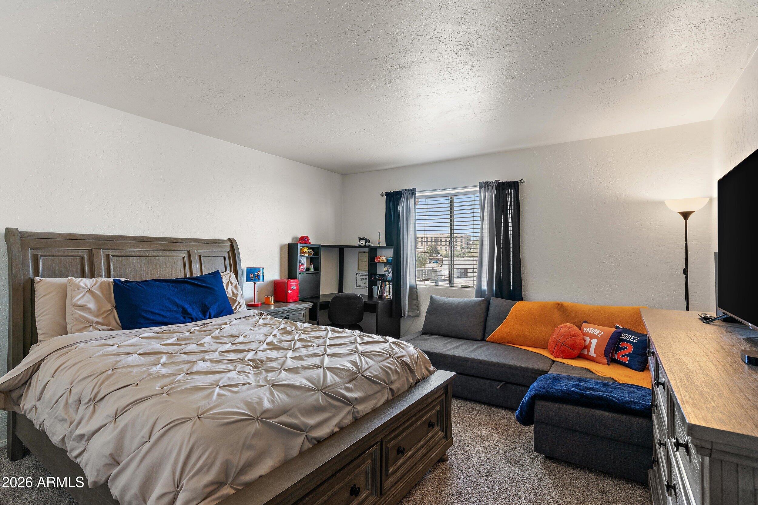 222 West Brown Road, Unit 57 Mesa, AZ 85201 - Photo 20 of 21 a bedroom with a bed and dresser