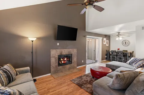 a living room with furniture a fireplace and a flat screen tv