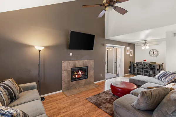 a living room with furniture a fireplace and a flat screen tv