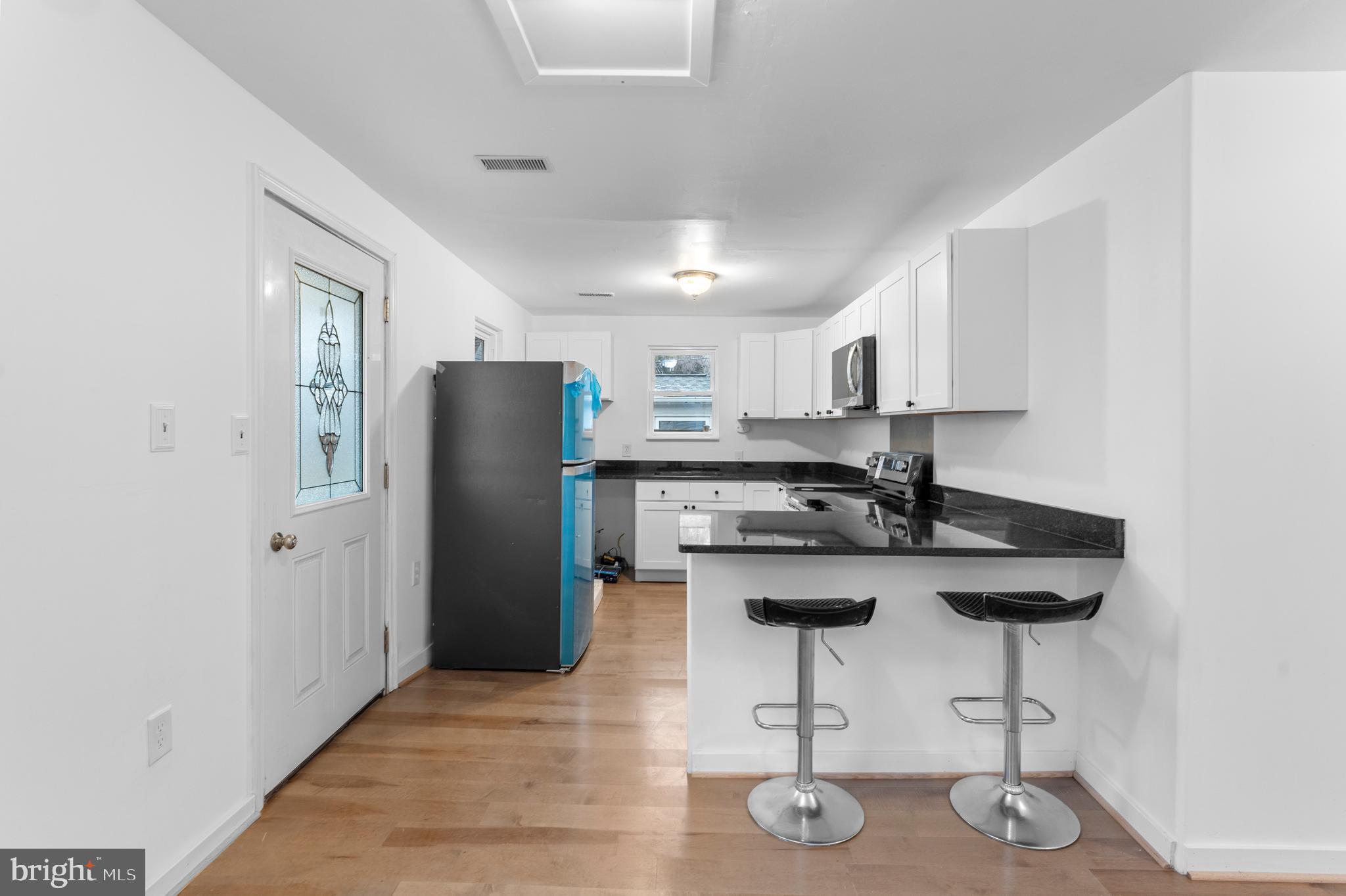 1504 Taylor Avenue, Unit B Parkville, MD 21234 - Photo 3 of 20 a kitchen with stainless steel appliances granite countertop a refrigerator and a stove top oven