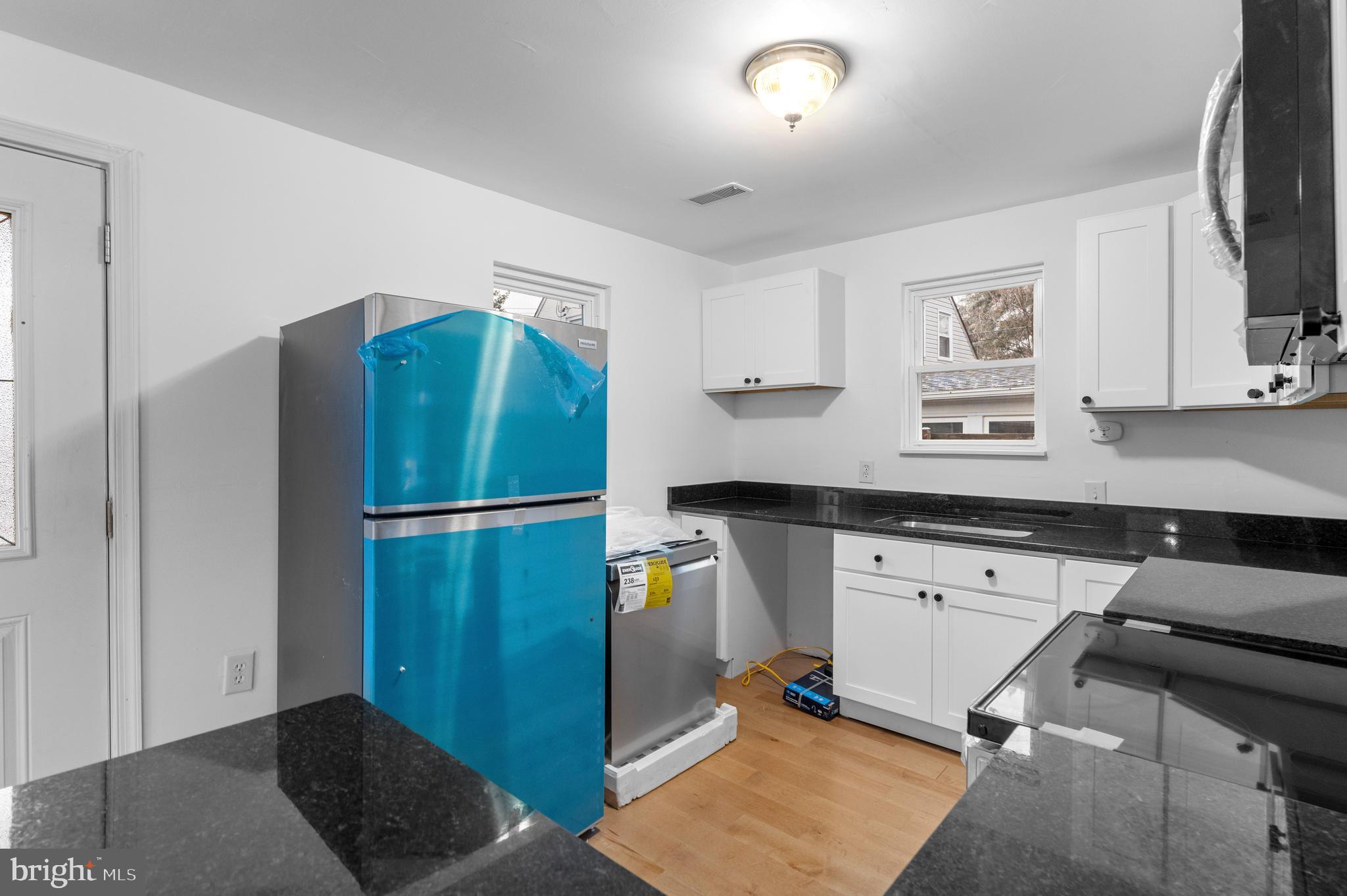 1504 Taylor Avenue, Unit B Parkville, MD 21234 - Photo 5 of 20 a kitchen with stainless steel appliances granite countertop a refrigerator and a stove top oven
