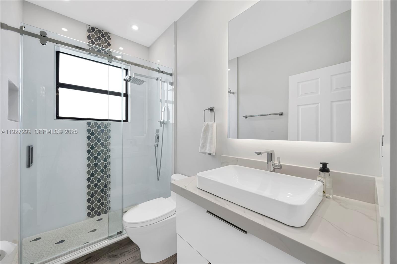 11448 Southwest 151st Path Miami, FL 33196 - Photo 14 of 35 a bathroom with a sink a toilet and shower