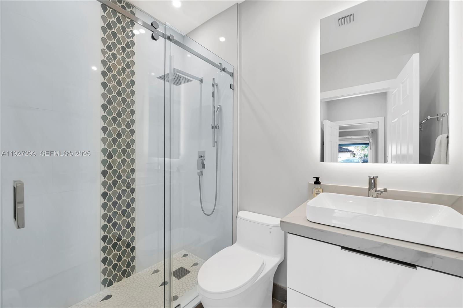 11448 Southwest 151st Path Miami, FL 33196 - Photo 17 of 35 a bathroom with a sink a toilet and shower