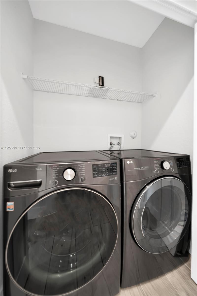 11448 Southwest 151st Path Miami, FL 33196 - Photo 19 of 35 a utility room with washing machine