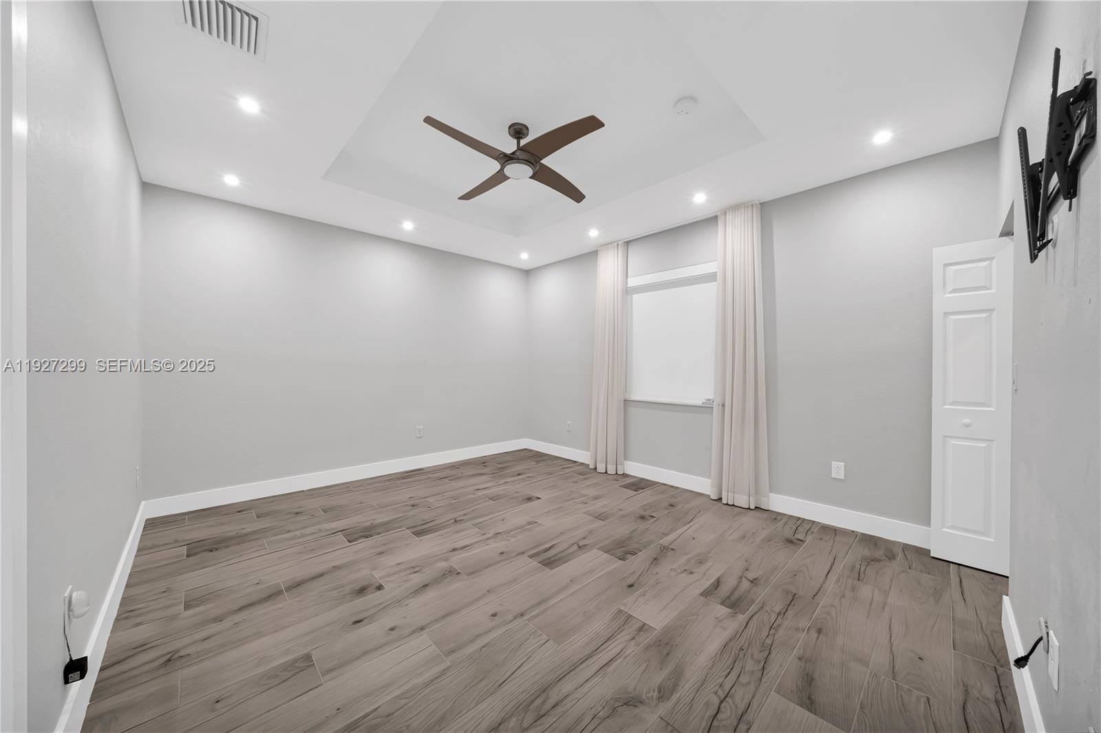 11448 Southwest 151st Path Miami, FL 33196 - Photo 20 of 35 an empty room with wooden floor and windows