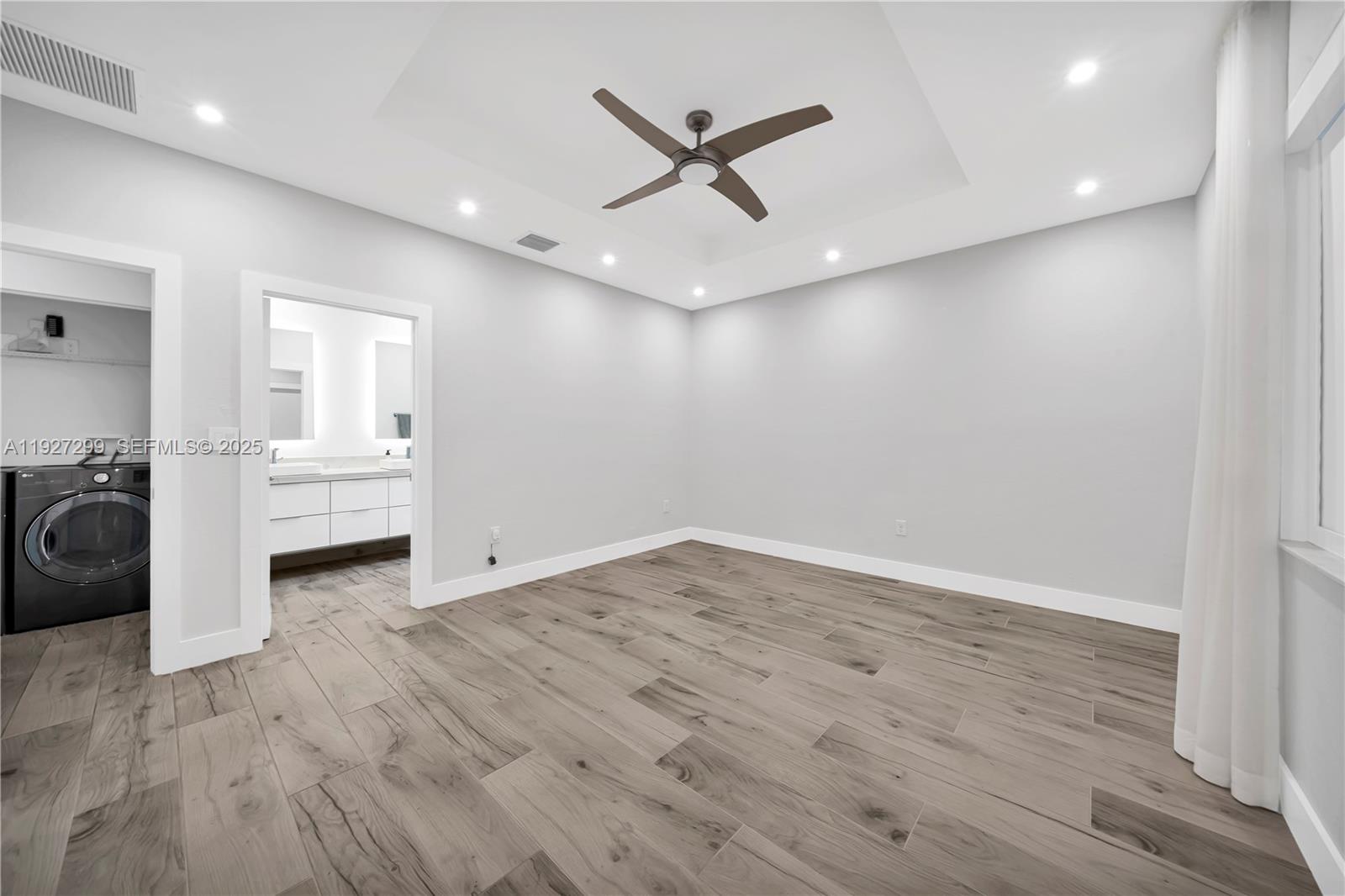 11448 Southwest 151st Path Miami, FL 33196 - Photo 22 of 35 a view of a livingroom with a ceiling fan and wooden floor