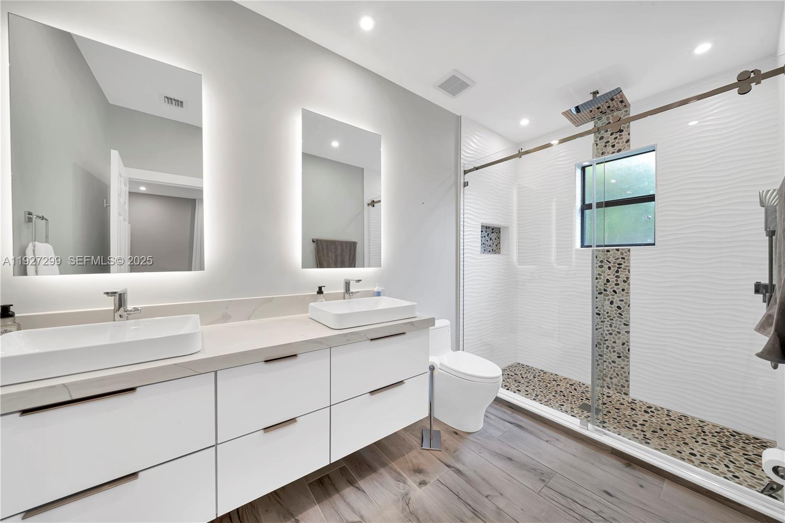 11448 Southwest 151st Path Miami, FL 33196 - Photo 24 of 35 a bathroom with a double vanity sink and mirror