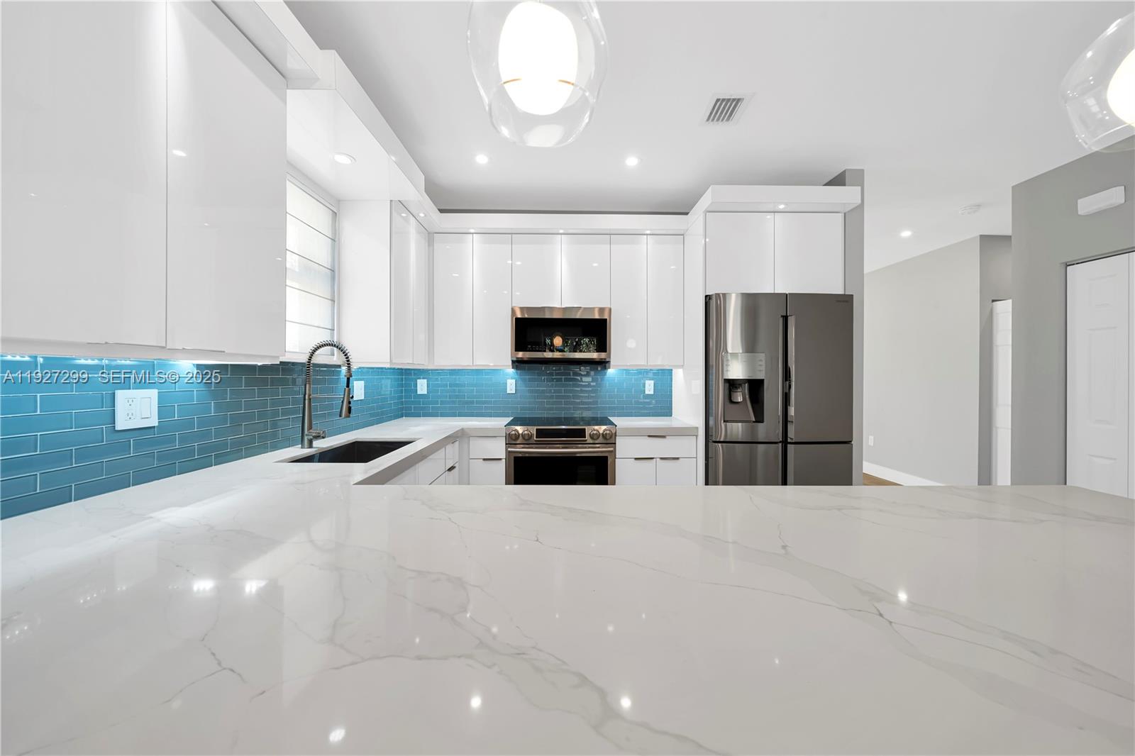 11448 Southwest 151st Path Miami, FL 33196 - Photo 5 of 35 a kitchen with stainless steel appliances a refrigerator sink and microwave