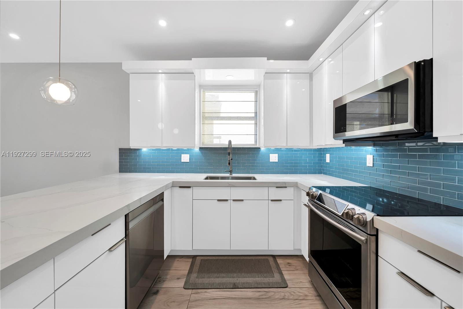 11448 Southwest 151st Path Miami, FL 33196 - Photo 6 of 35 a kitchen with a sink stove and microwave