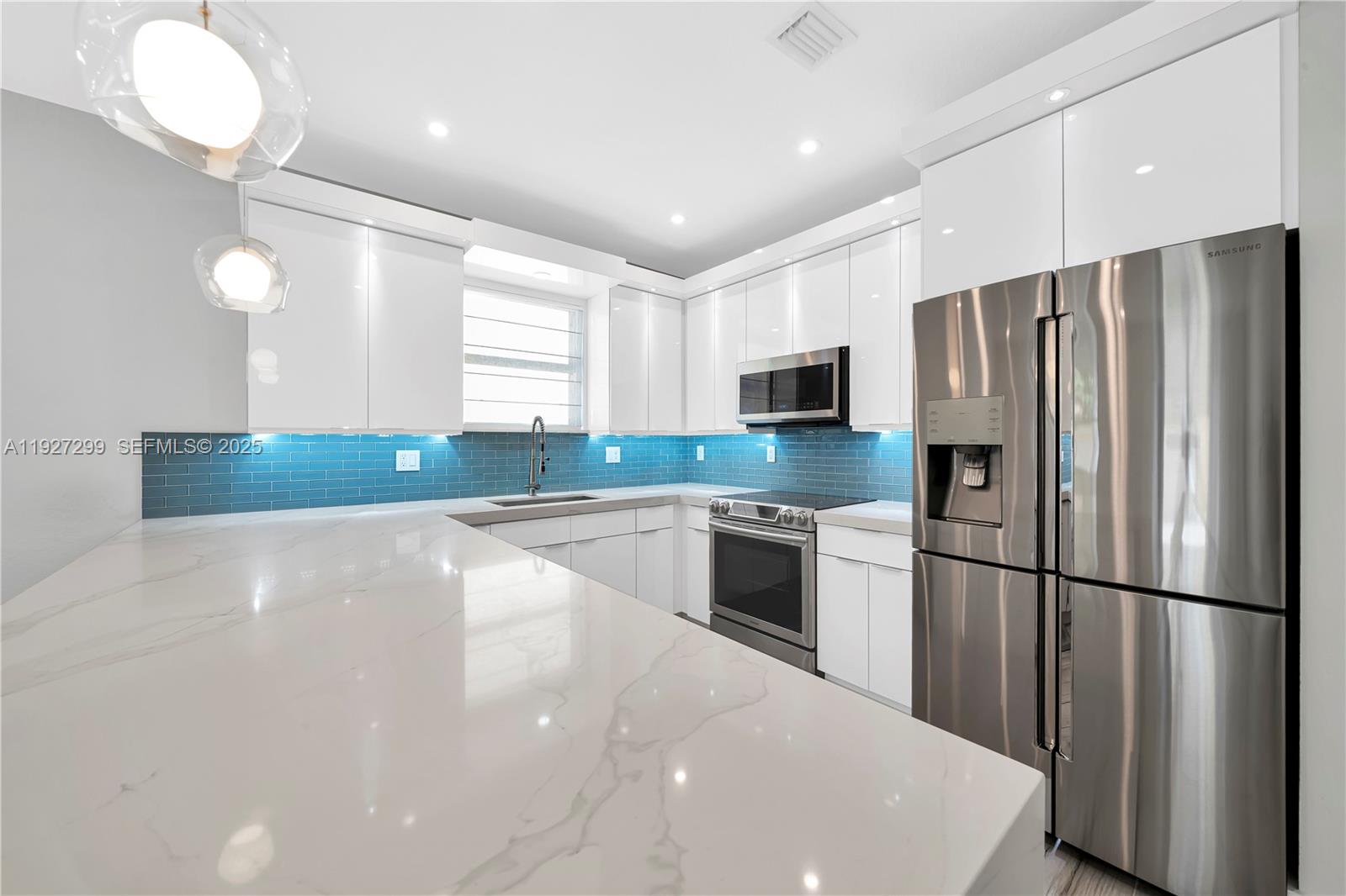 11448 Southwest 151st Path Miami, FL 33196 - Photo 7 of 35 a kitchen with stainless steel appliances a refrigerator sink and microwave