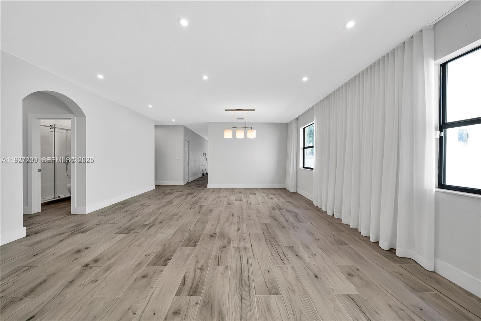 11448 Southwest 151st Path Miami, FL 33196 - Photo 8 of 35 an empty room with wooden floor and windows