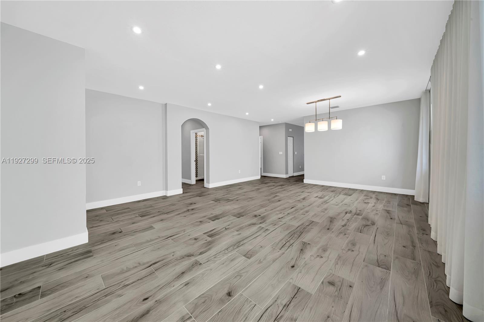 11448 Southwest 151st Path Miami, FL 33196 - Photo 9 of 35 a view of empty room with wooden floor