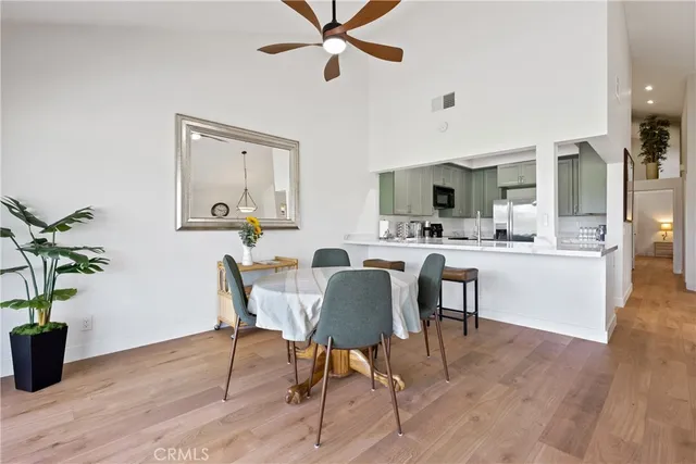a large kitchen with granite countertop a sink and a large mirror next to a window