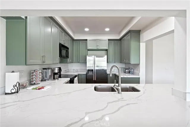 a kitchen with a refrigerator sink and microwave