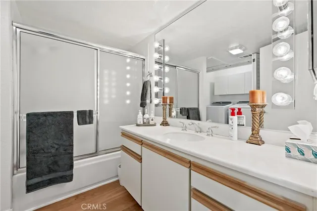 a spacious bedroom with a bed and wooden floor