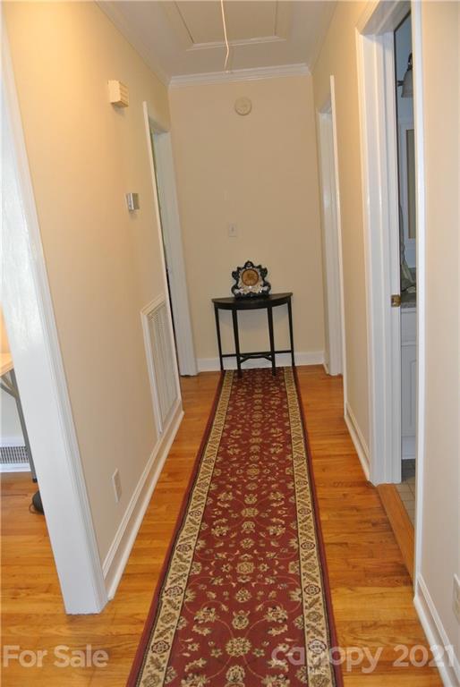 173 Tanner Street Rutherfordton, NC 28139 - Photo 12 of 25 a view of a hallway with wooden floor and stairs