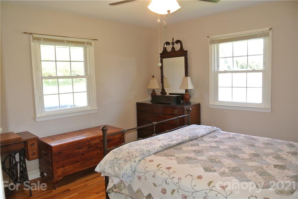 173 Tanner Street Rutherfordton, NC 28139 - Photo 13 of 25 a bedroom with a bed and wooden floor