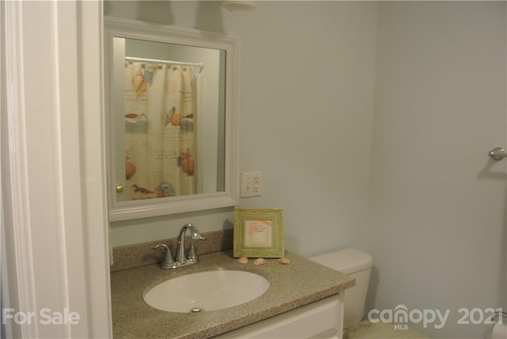 173 Tanner Street Rutherfordton, NC 28139 - Photo 14 of 25 a bathroom with a granite countertop sink and a mirror