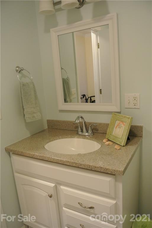 173 Tanner Street Rutherfordton, NC 28139 - Photo 15 of 25 a bathroom with a granite countertop sink and a mirror
