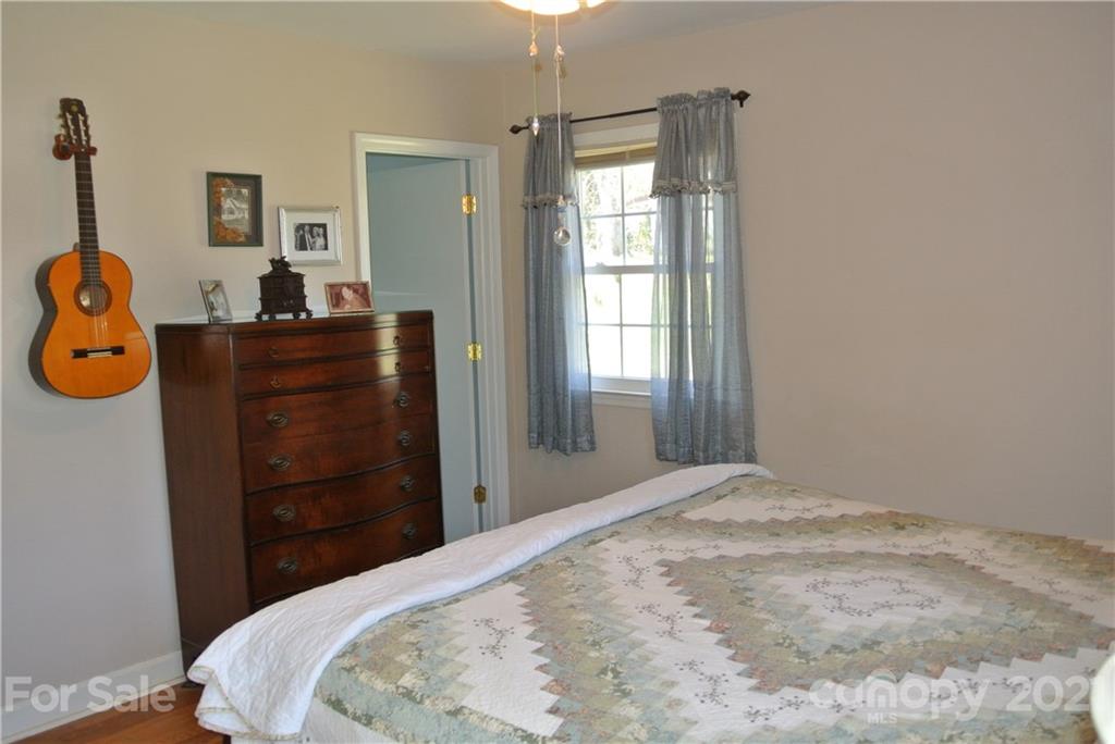 173 Tanner Street Rutherfordton, NC 28139 - Photo 17 of 25 a bedroom with a bed and wooden floor