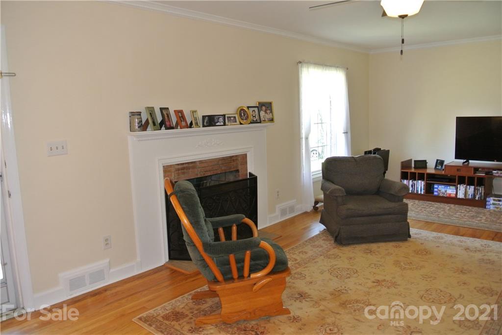 173 Tanner Street Rutherfordton, NC 28139 - Photo 5 of 25 a living room with furniture and a fireplace